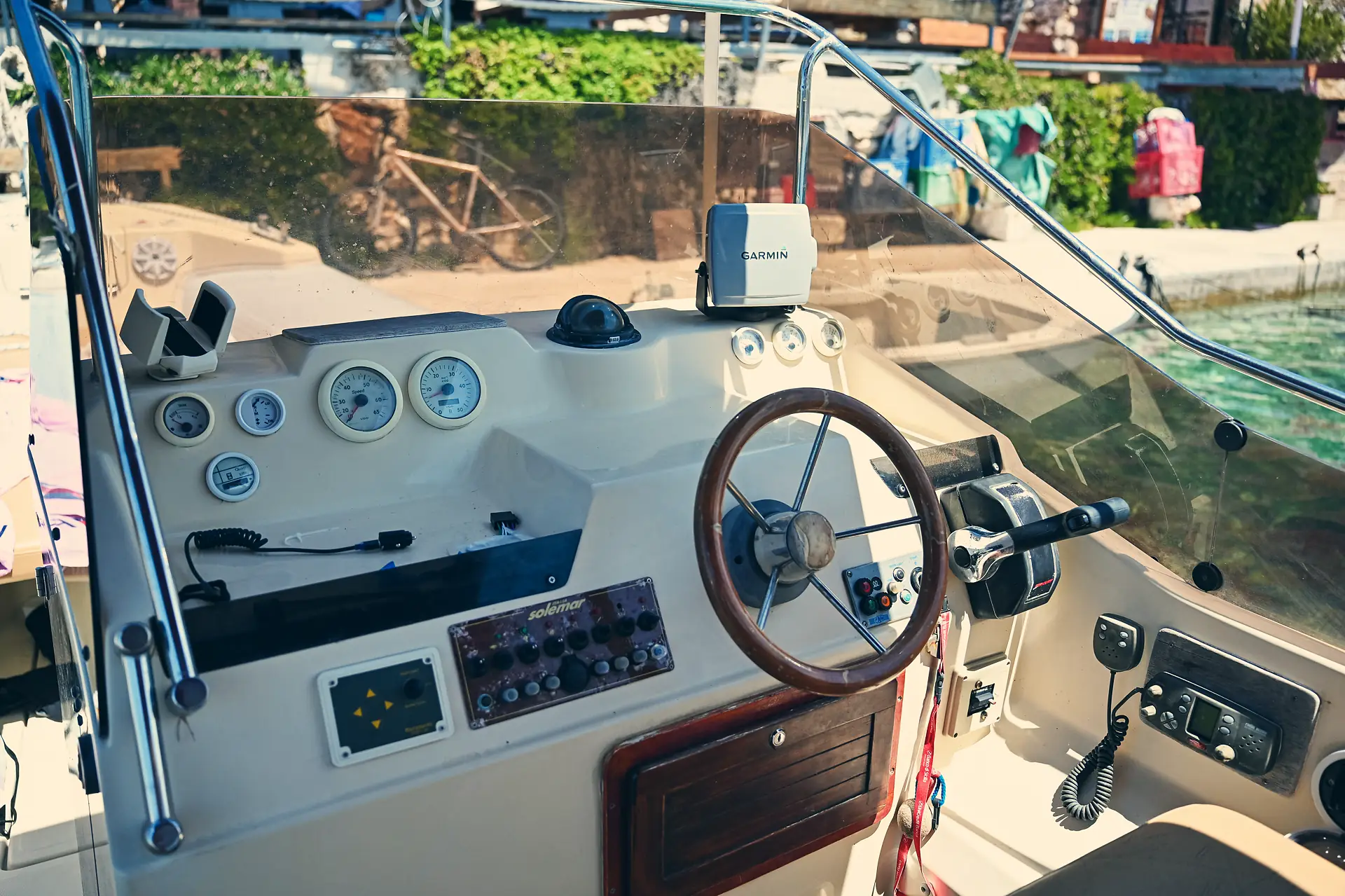 Local skipper at the wooden helm of the ADV Yachting speedboat